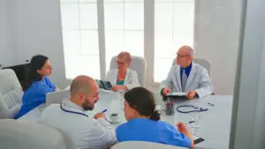 healthcare workers having meeting hospital conference room about symptoms patients analysing x ray clinic expert therapist talking with colleagues about disease medicine professional Digital Ware