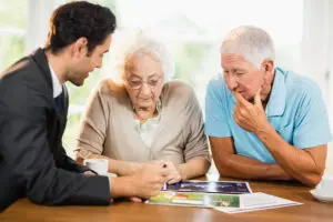 businessman showing sheets senior couple home Digital Ware